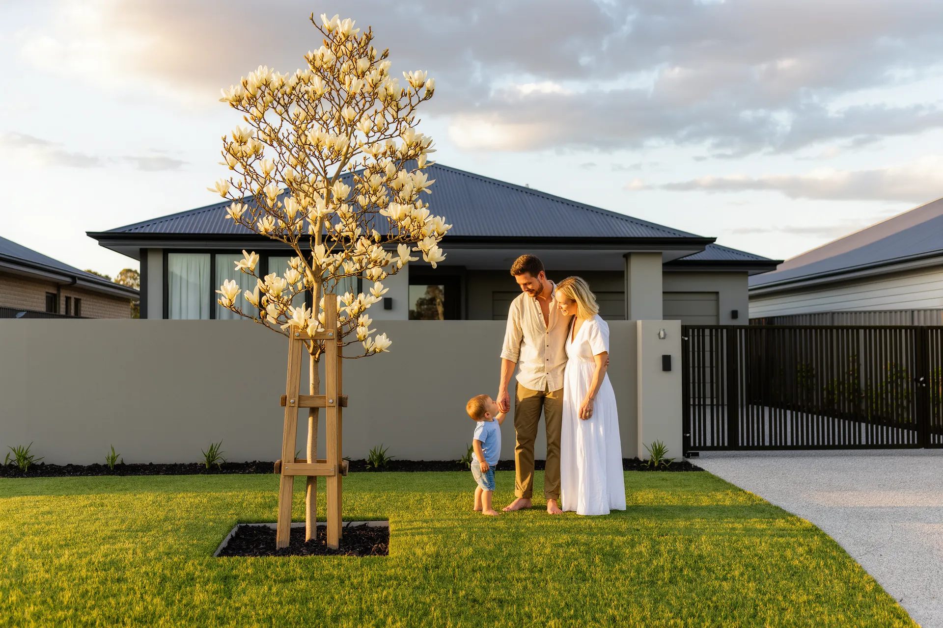 Family in front of a new home in the Melton East catchment
